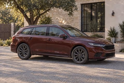 Vehicle example: an oxblood estate wagon in a courtyard, illustrative photograph